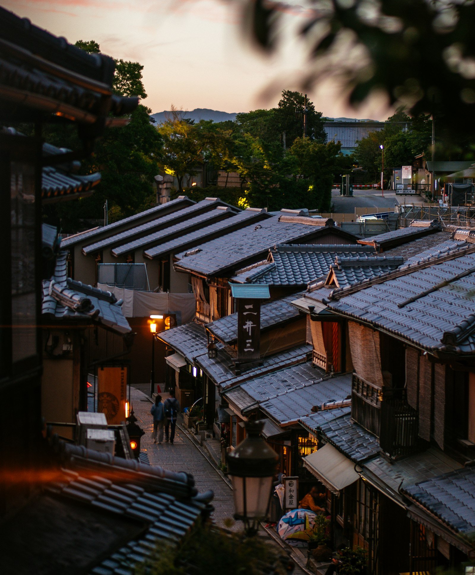 Narrow street lined with traditional wooden machiya houses in Gion, Kyoto