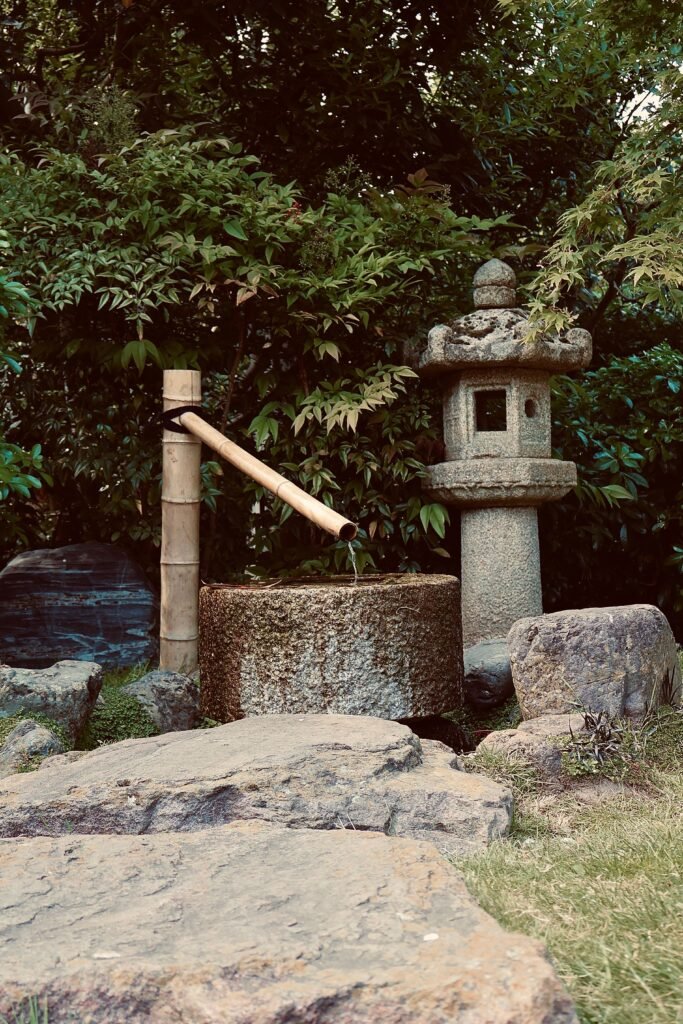A traditional stone water basin (tsukubai) in a Kyoto temple garden