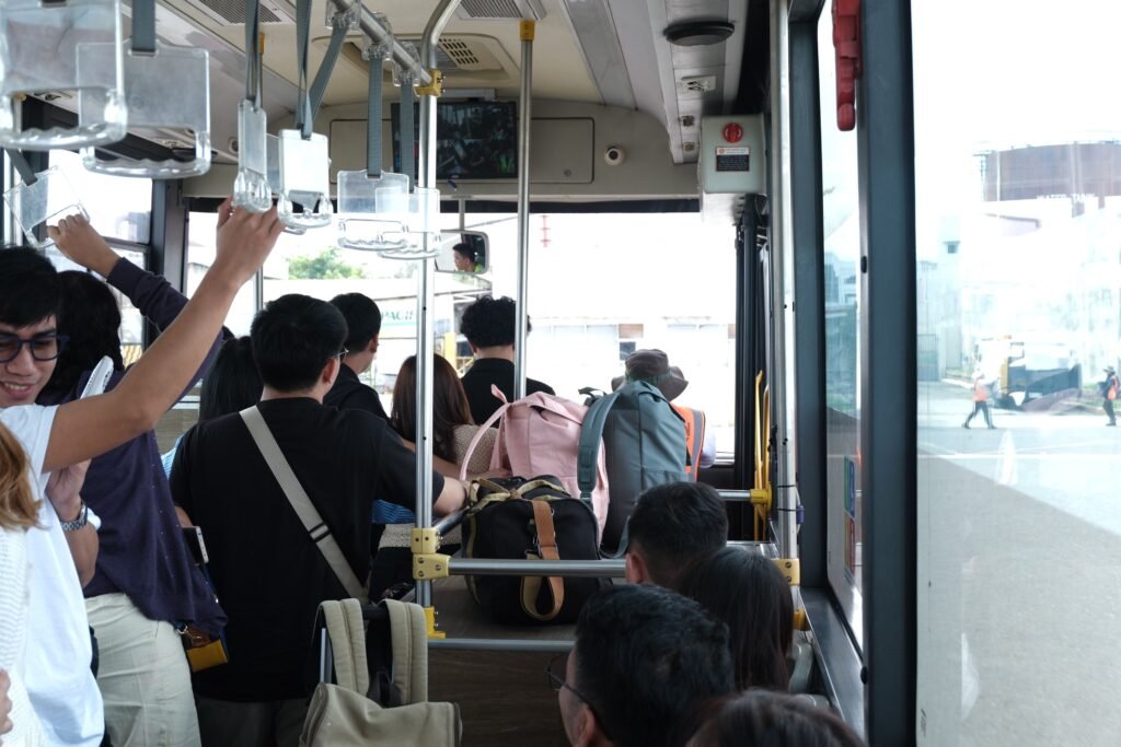 Commuters holding onto rails inside a crowded city bus