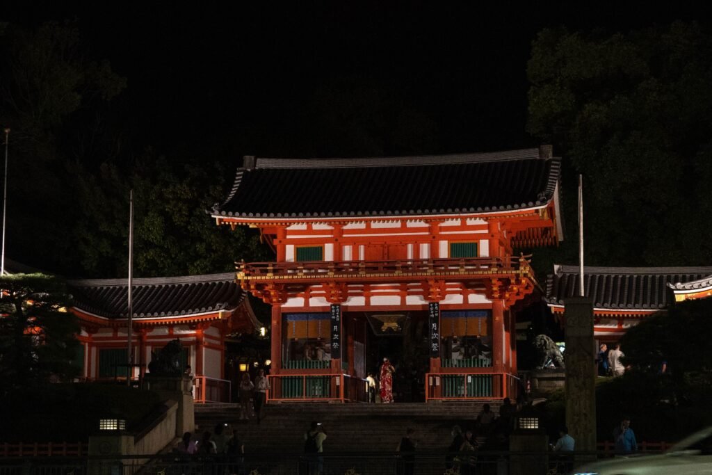 Yasaka Shrine entrance lit up with lanterns at night in Kyoto