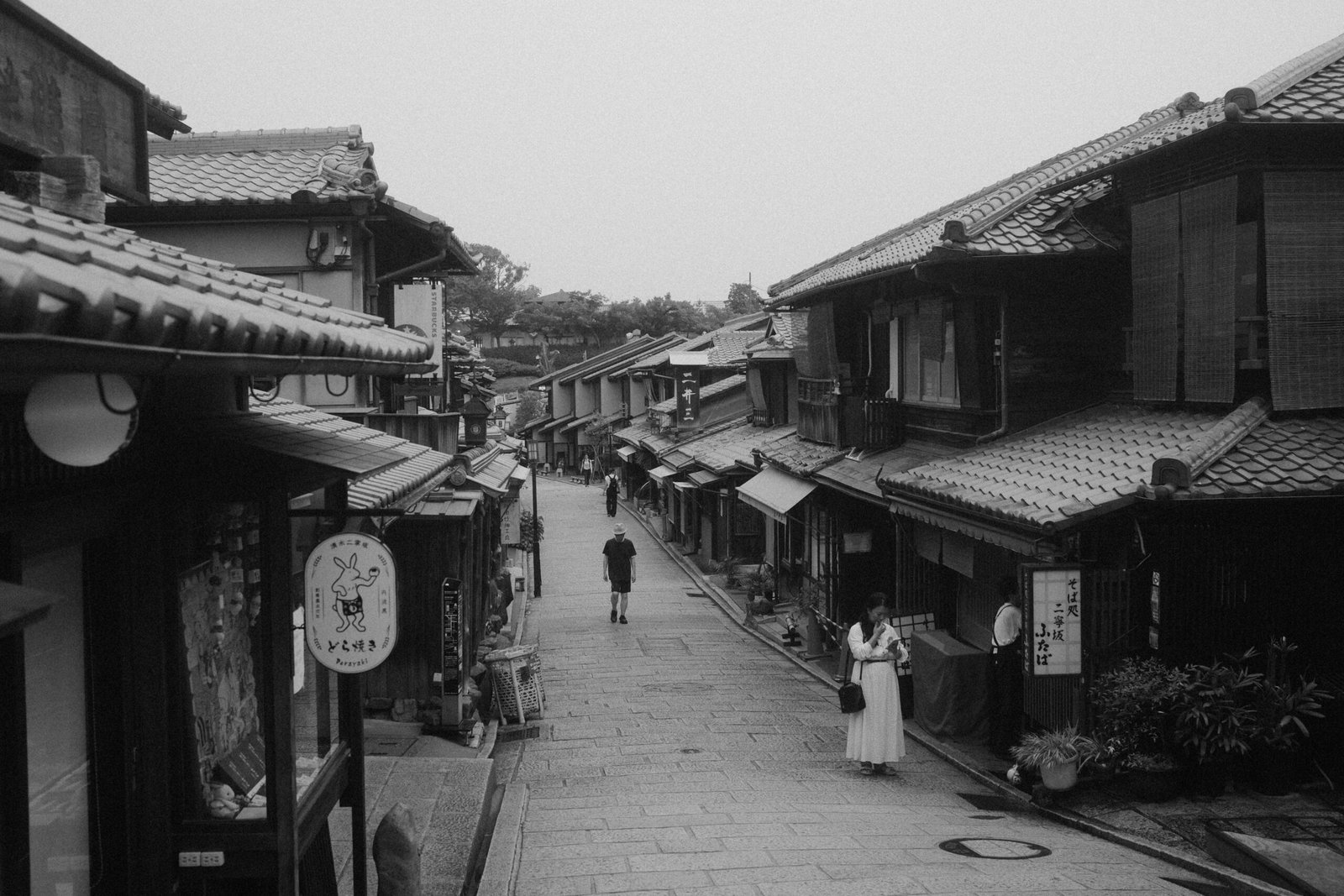 A traditional street scene in Kyoto lined with wooden buildings