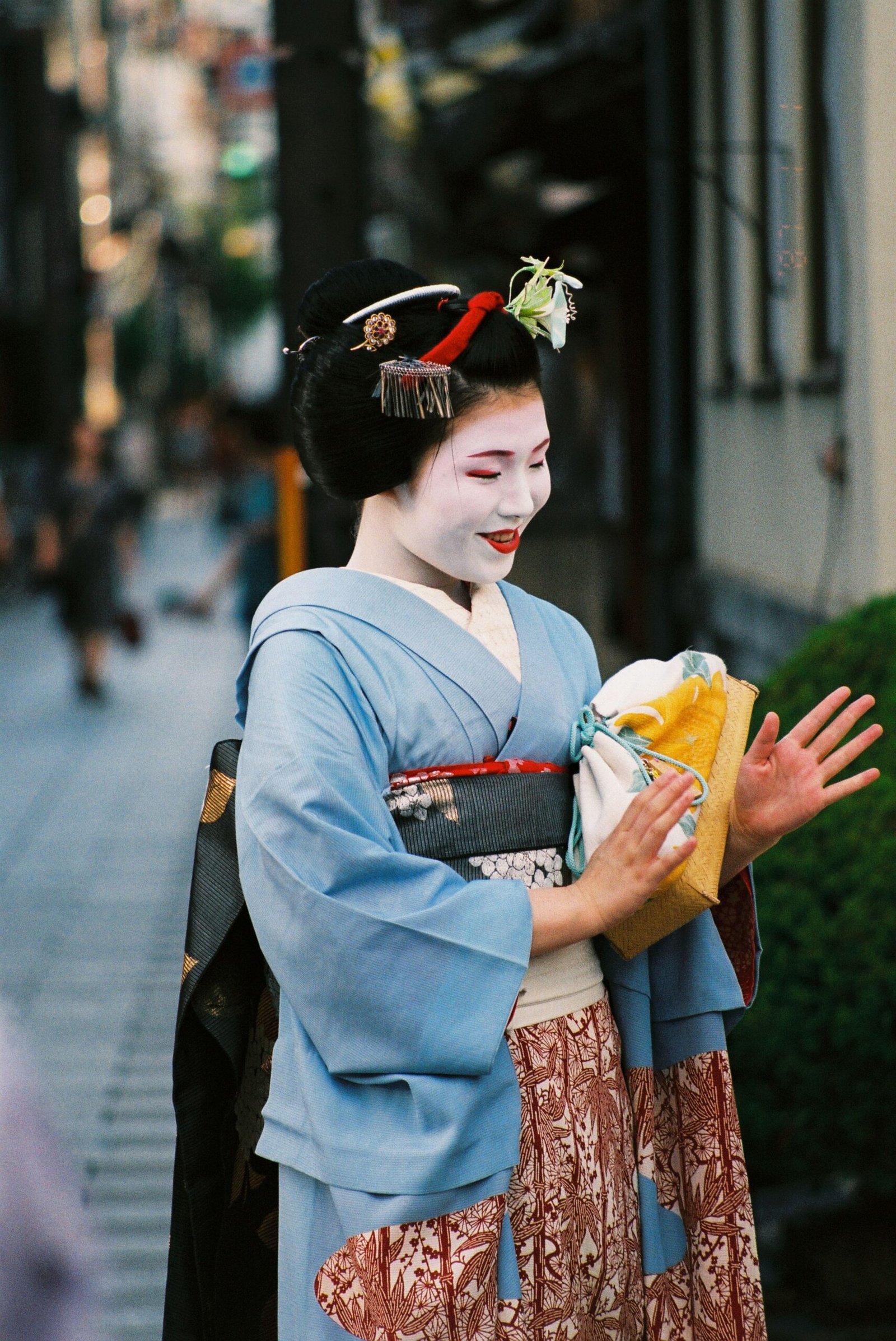 A geisha walking through a traditional Kyoto street