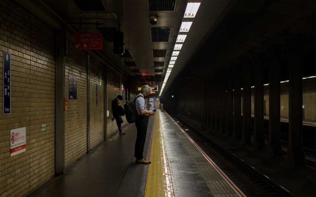 A passenger waiting on a subway platform in Kyoto