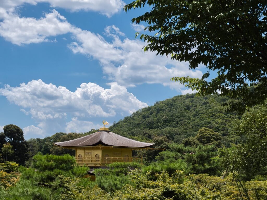 Kinkaku-ji temple grounds amid lush greenery, Kyoto