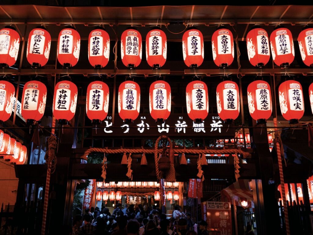 Colorful lanterns lighting up a festival street during Yoiyama in Kyoto