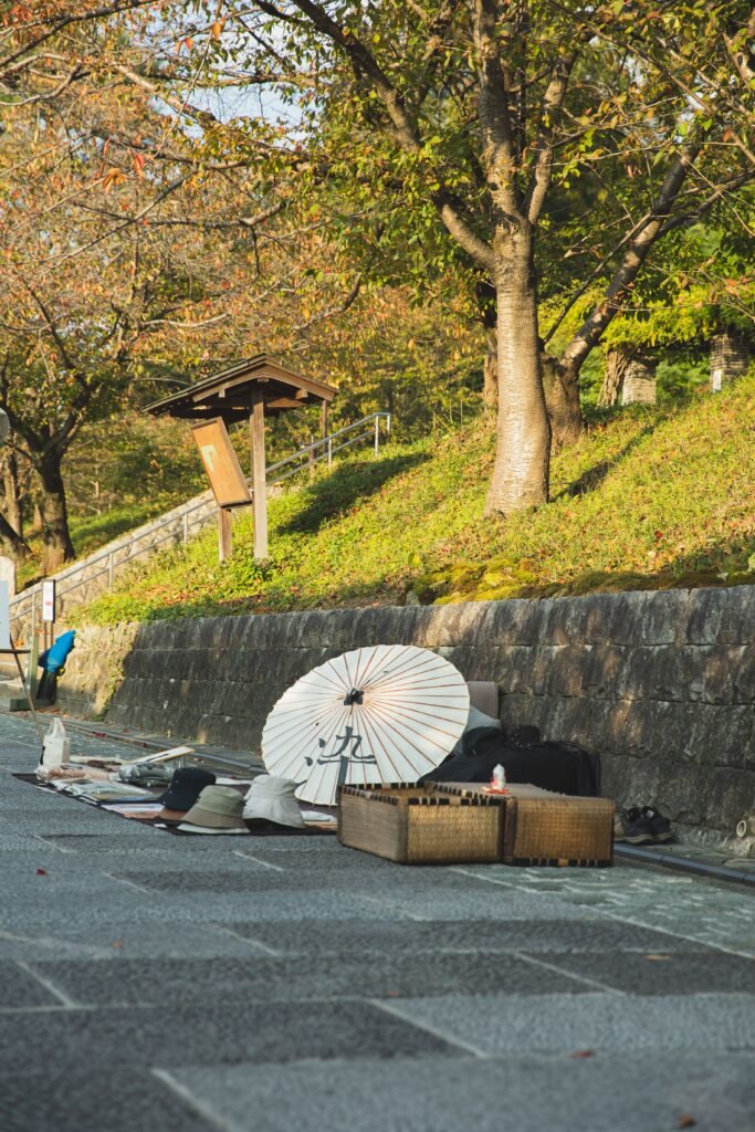 Traditional items for sale at an outdoor market stall in Kyoto