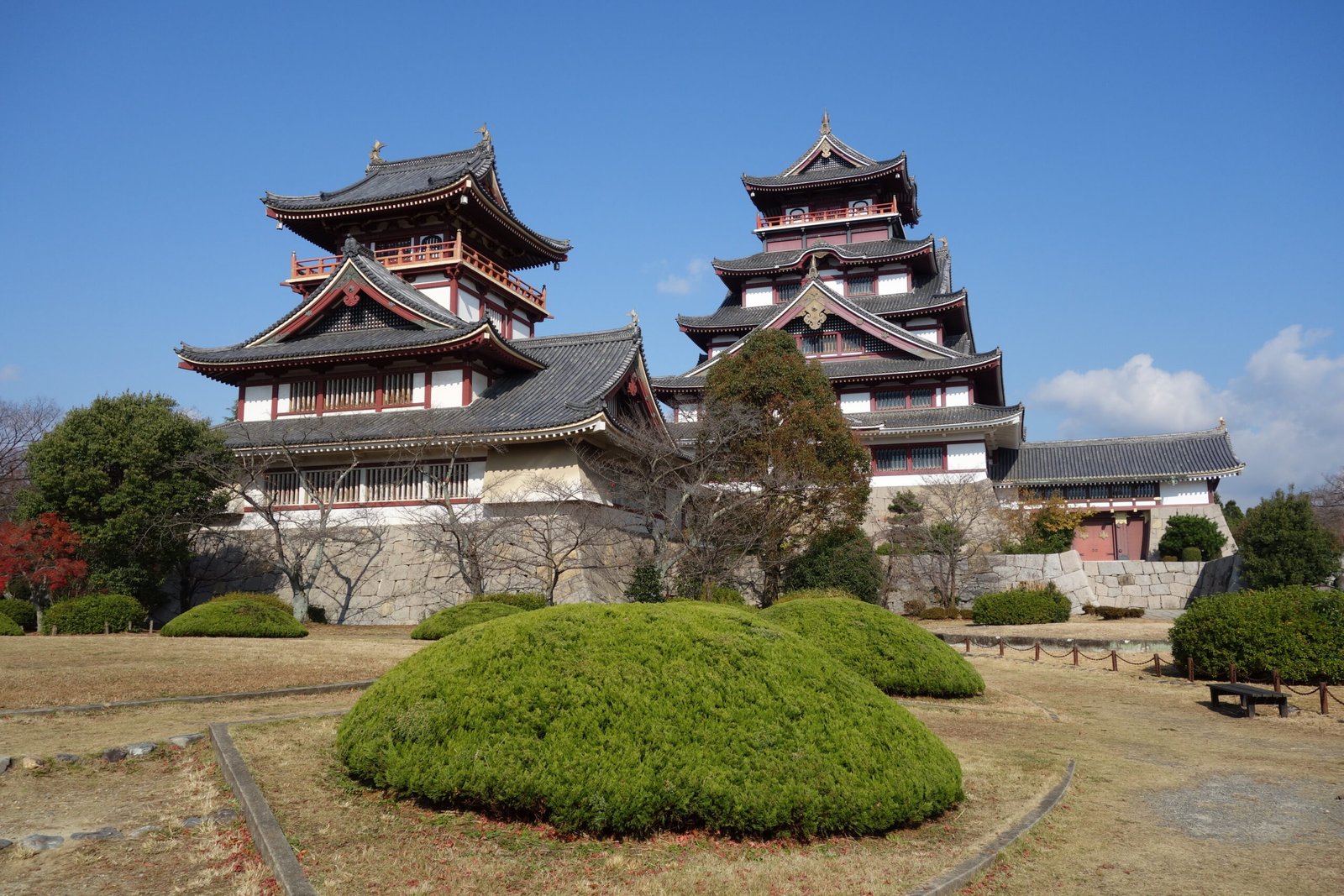Fushimi Momoyama Castle's twin keeps rising above the trees in Kyoto